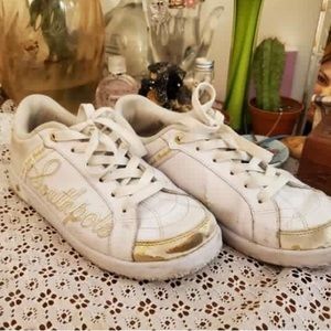 White and gold Southpole sneakers.